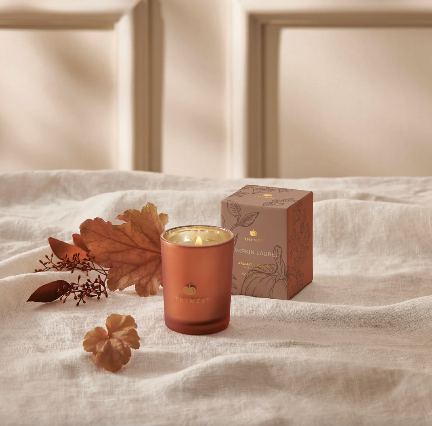 Thymes Pumpkin Laurel Votive Candle Candles in  at Wrapsody